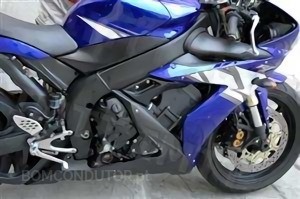While riding, can sudden acceleration that does not cause skidding compromise the stability of a motorcycle?