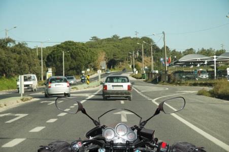 Can riding over road markings be dangerous for riders of two-wheeled vehicles?