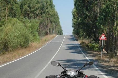 When riding a motorcycle, may an intercom be used to communicate with the passenger?