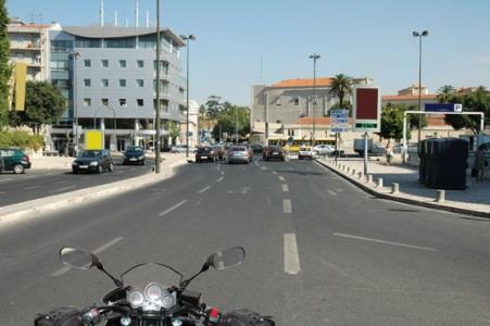 In well-lit built-up areas, the motorcyclist should ride: