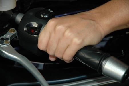 I should ride a motorcycle with both hands on the handlebars, except when: