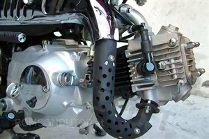 What is the lubrication process of a two-stroke engine?