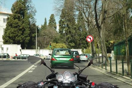 In a built-up area, during the day, motorcycles must ride: